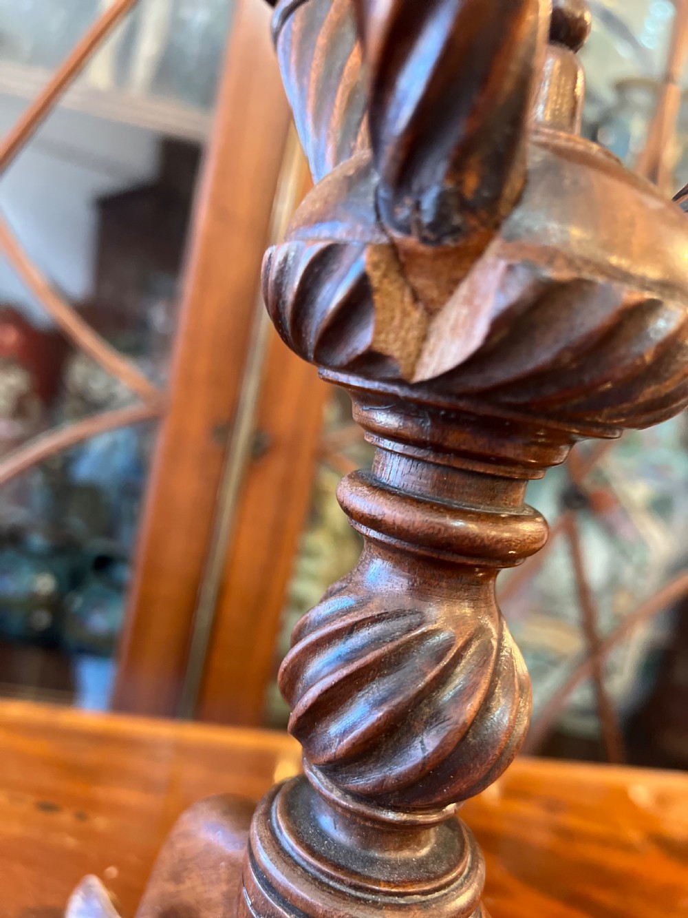 An early nineteenth-century turned wood treen plate stand featuring three spiral-carved upper arms above a turned central column and tripod base. View IX