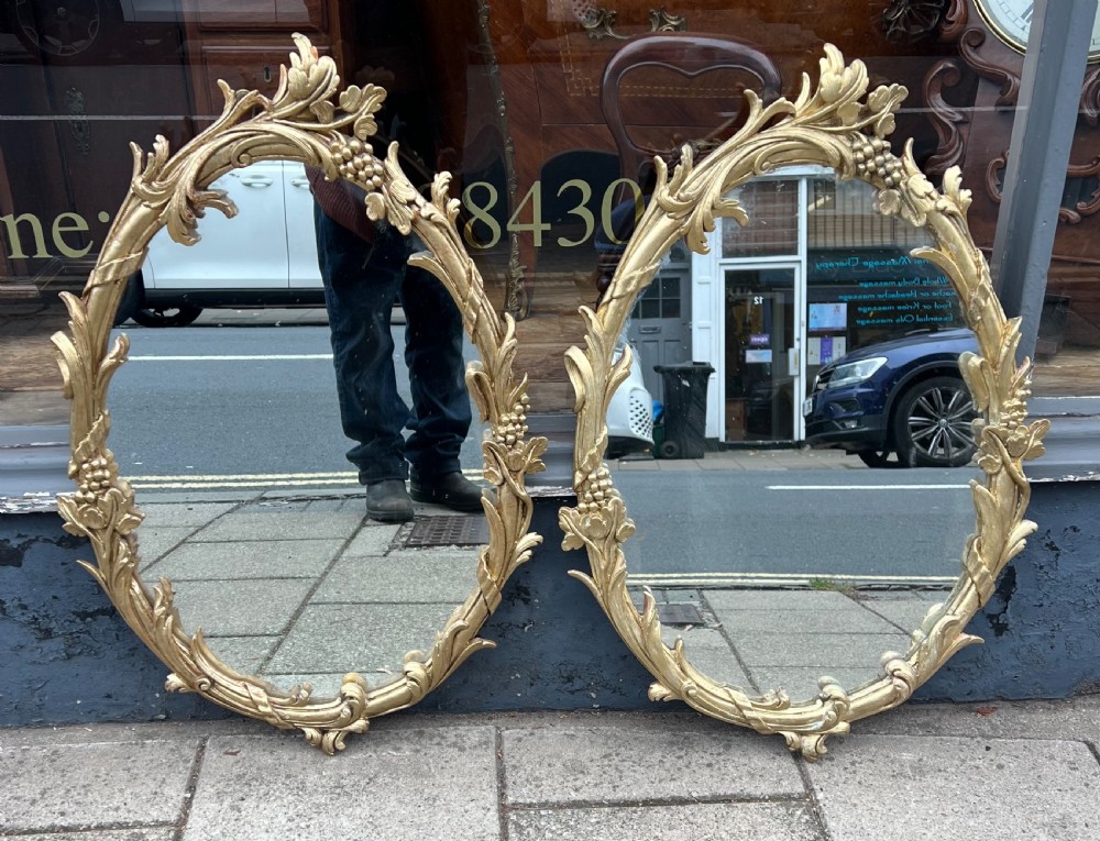 Pair of carved giltwood oval mirrors  View XIII