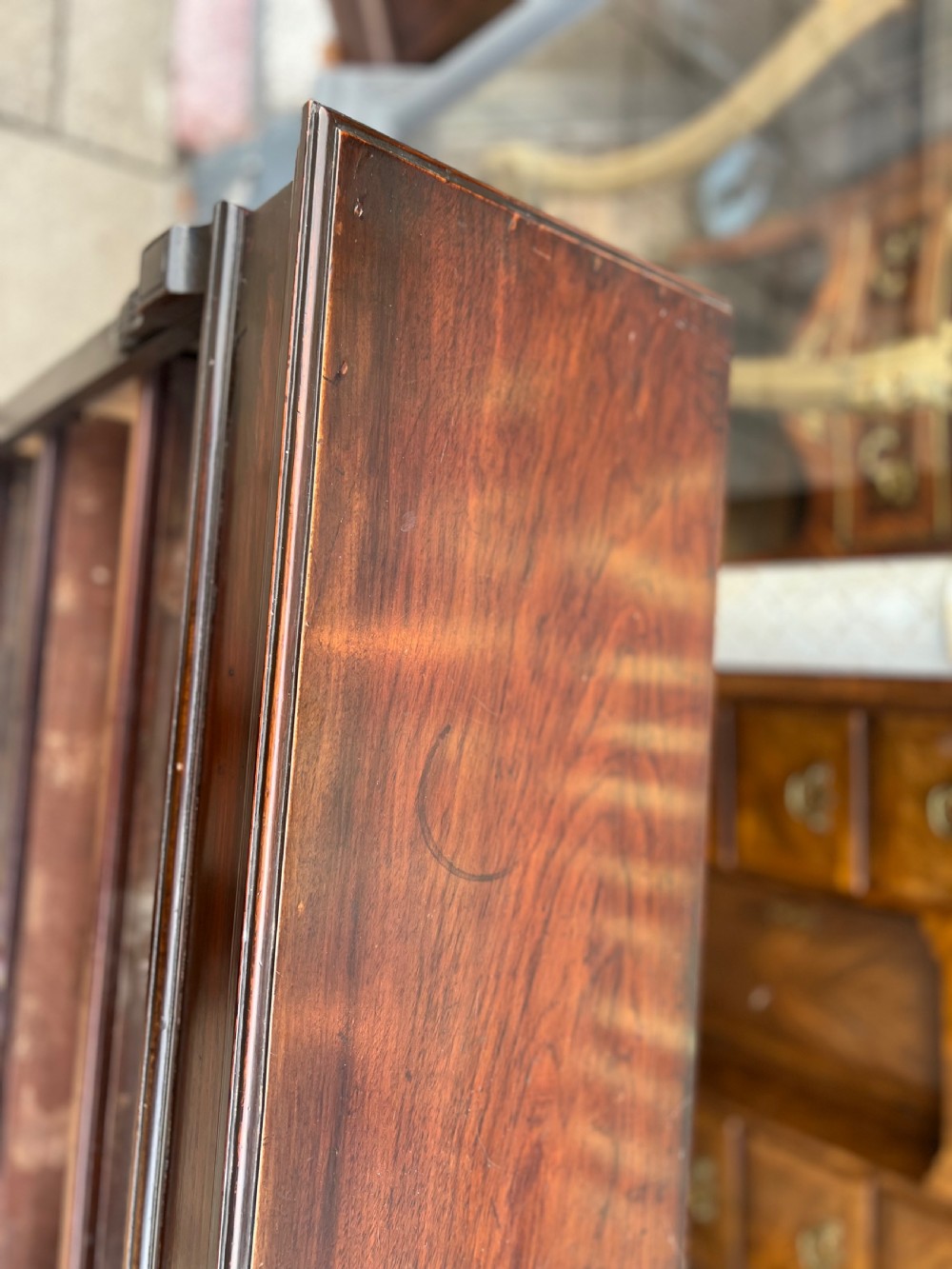 An Edwardian open walnut bookcase featuring four adjustable wooden shelves, side corbel carvings, and a solid plinth base. View VIII