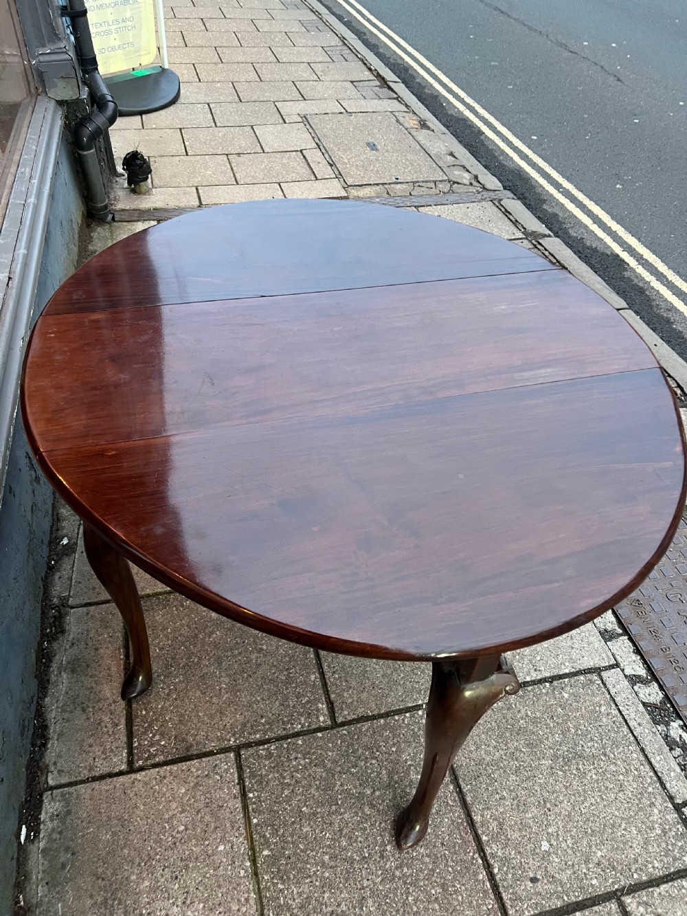 An 18th-century Cuban mahogany drop leaf table with curved cabriole legs and carved pointed pad feet. View VIII