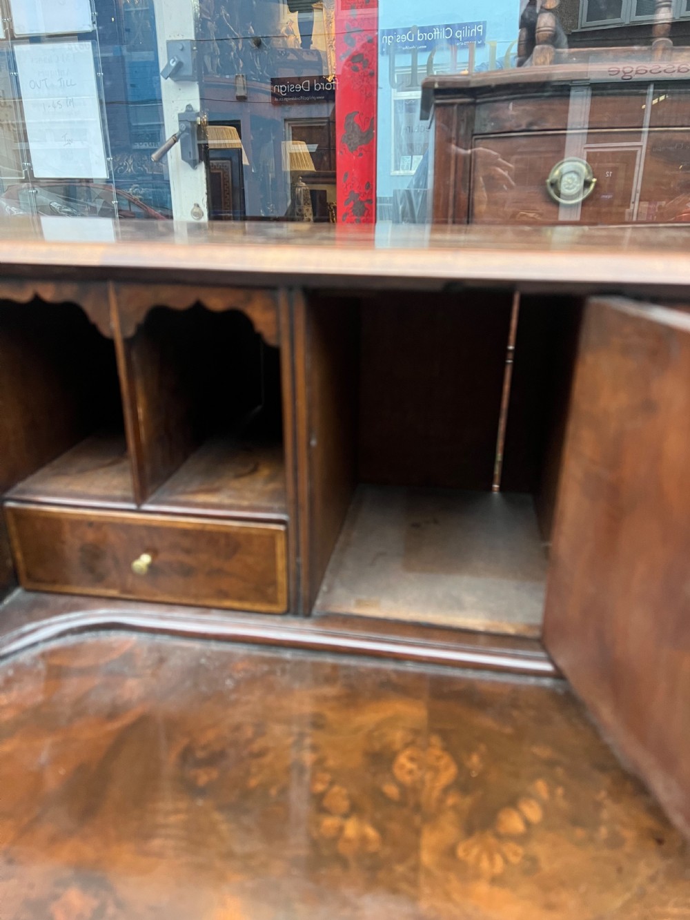 An 18th-century walnut and burr walnut slant-front bureau featuring crossbanded drawers, brass drop handles, and bracket feet. View VII