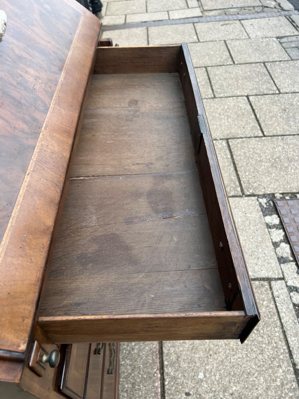 An 18th-century walnut and burr walnut slant-front bureau featuring crossbanded drawers, brass drop handles, and bracket feet. View IX