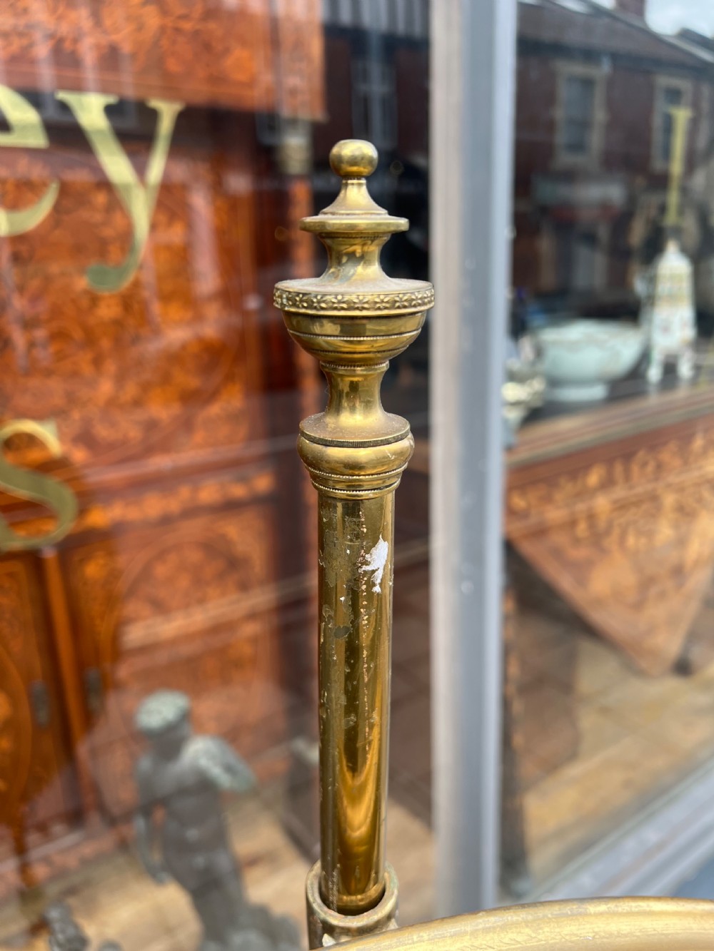 A 19th-century gilded pole screen with a tripod Rococo base framing an oval needlepoint panel depicting flowers and a bird. View IX