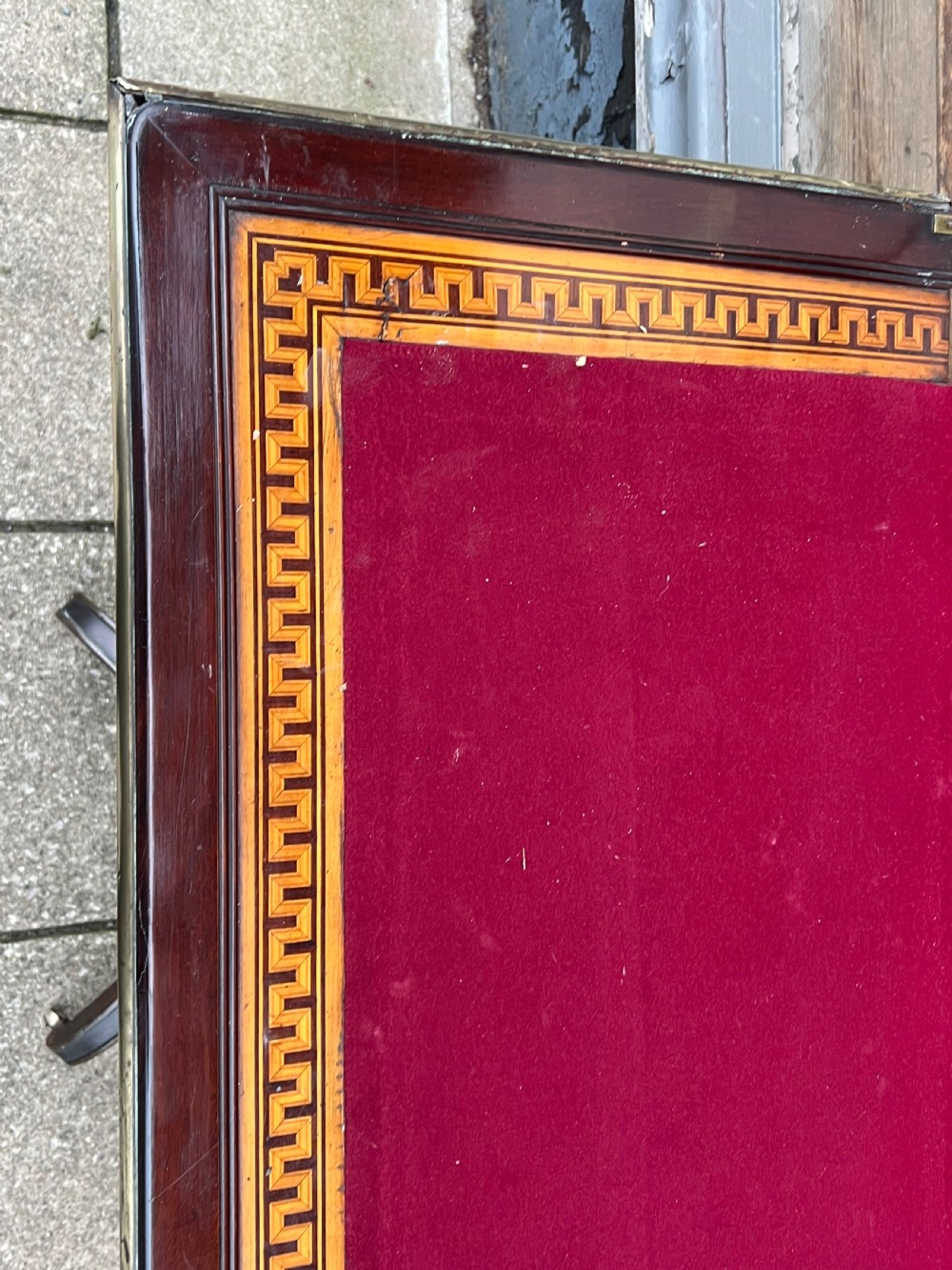 A Regency mahogany card table with brass edging, fold-over top, and quadform pedestal base on castors. View VII