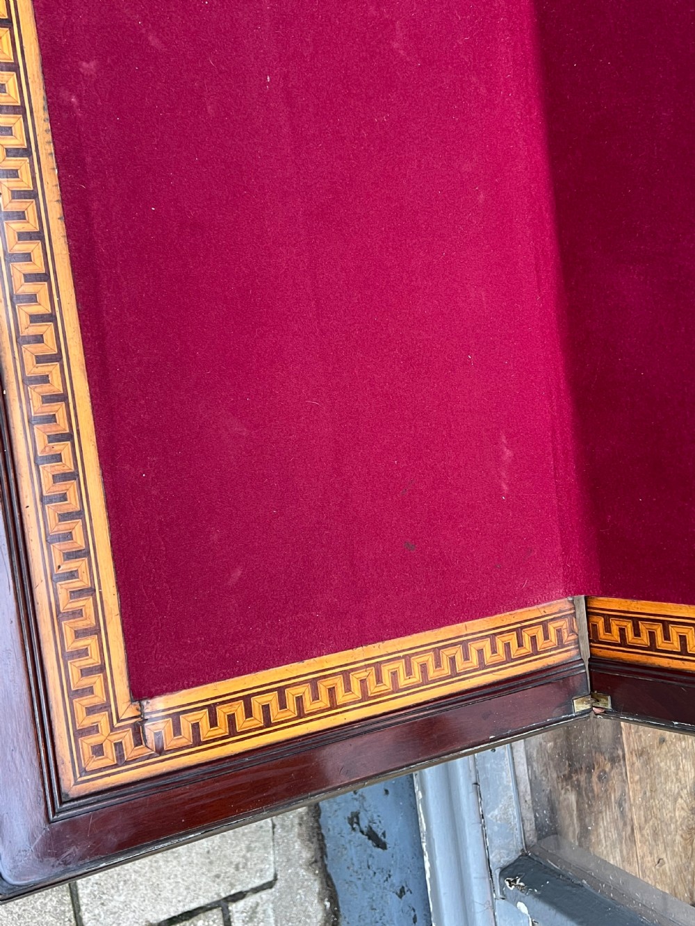 A Regency mahogany card table with brass edging, fold-over top, and quadform pedestal base on castors. View VIII