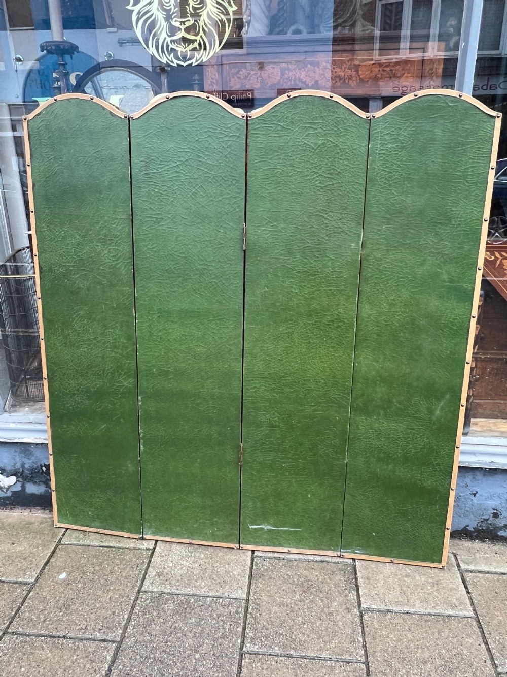 A four-panel arched folding screen featuring a large hand-painted floral still life in a blue vase set on a wooden table surface against a warm brown background. View VI