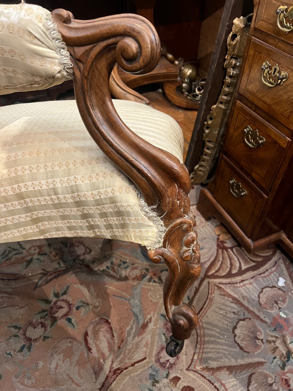 A Victorian rosewood showwood armchair featuring striped gold satin upholstery, button-tufted backrest, scrolled arms, and carved cabriole legs with castors. View II
