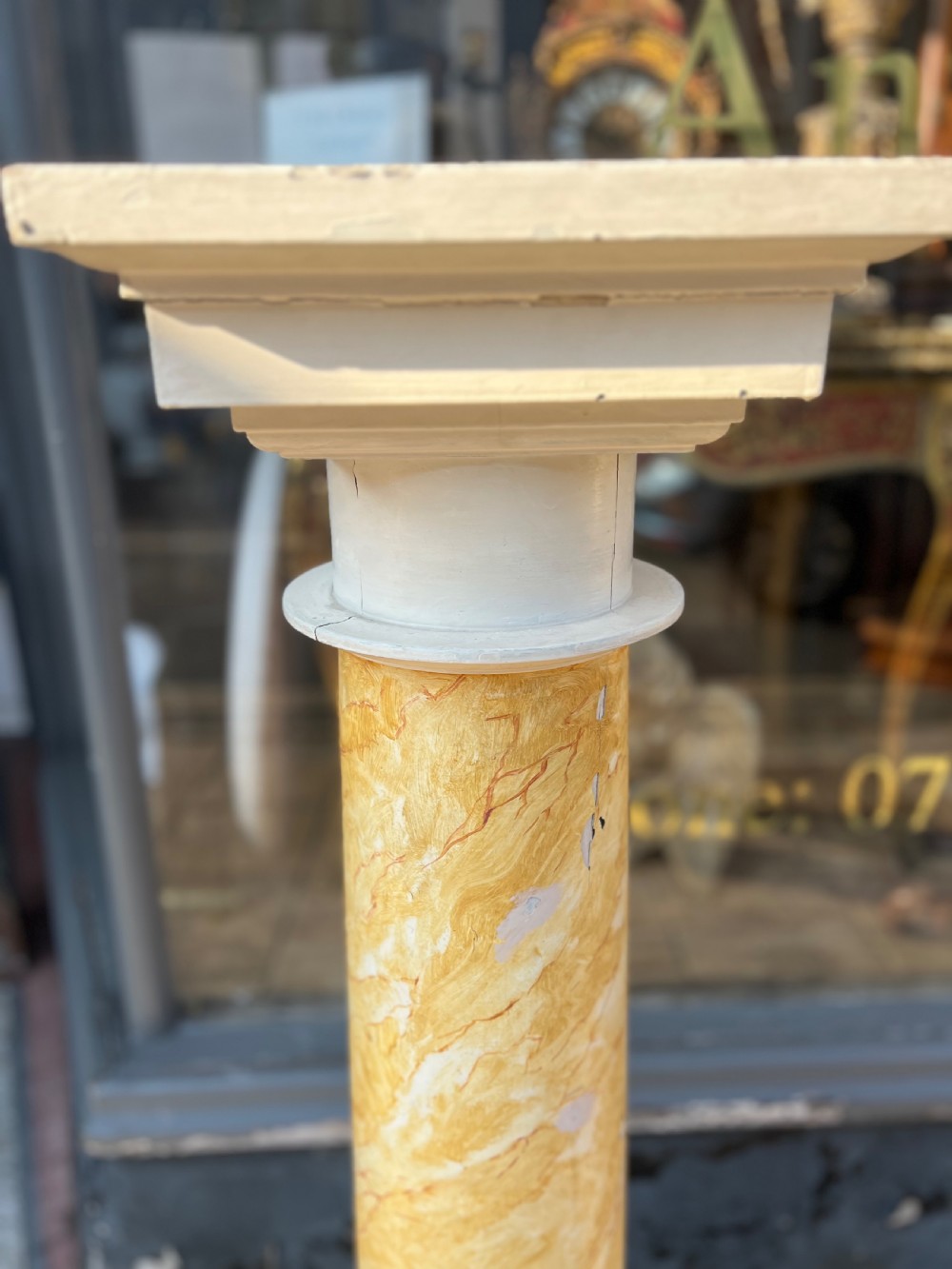A 19th-century architectural column pedestal featuring hand-painted yellow faux marble veining with a cream-painted capital and base. View III