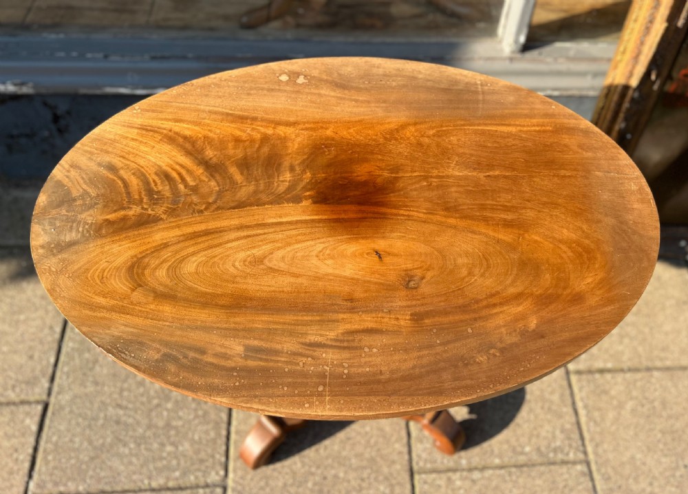 A nineteenth-century oval wooden occasional table featuring a beaded apron, turned central pedestal, and a four-legged scrolled base. View II