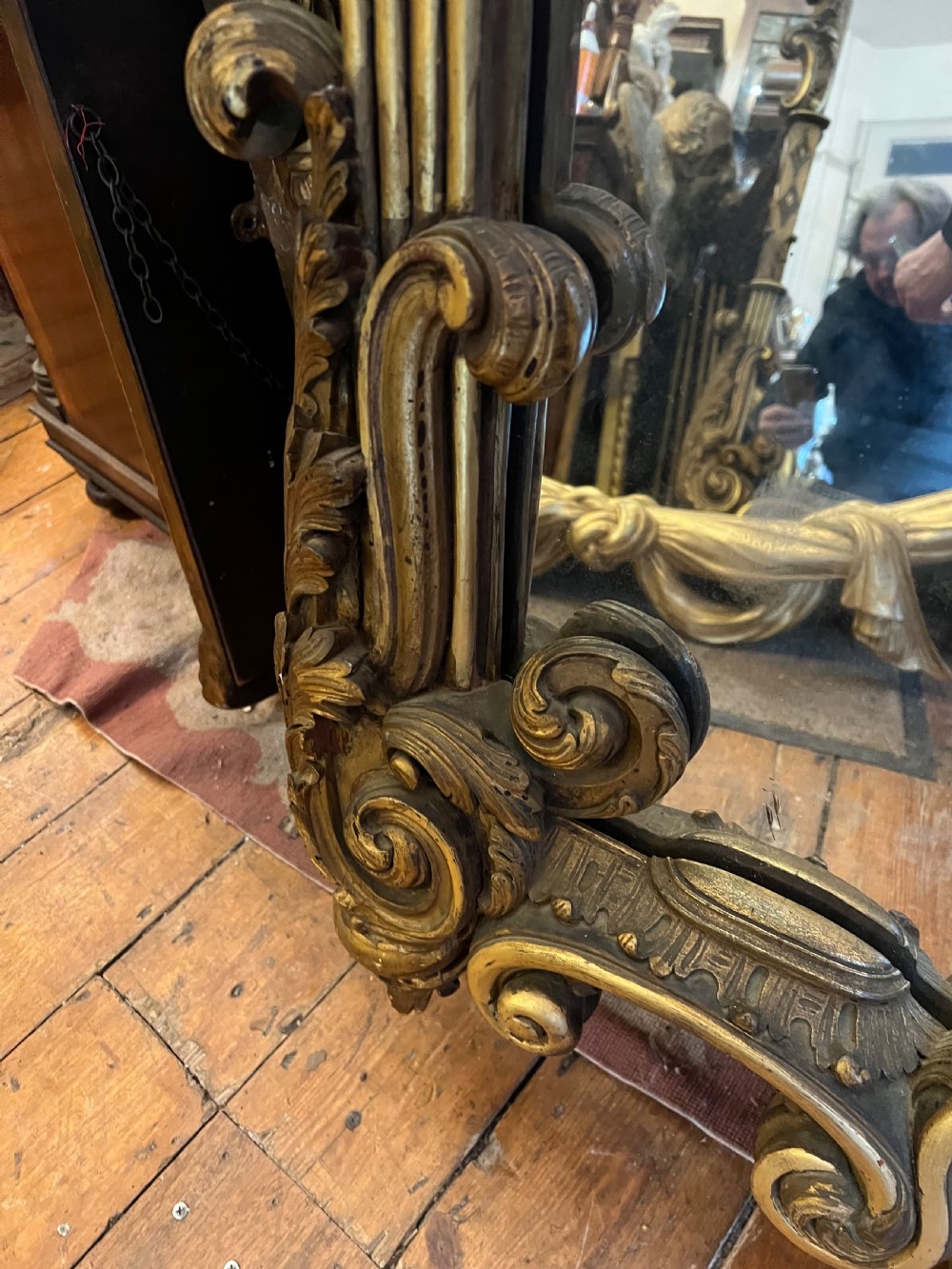 A 19th-century carved giltwood pier mirror featuring a Rococo cresting, scrolling acanthus leaf details, and an arched upper frame. View II