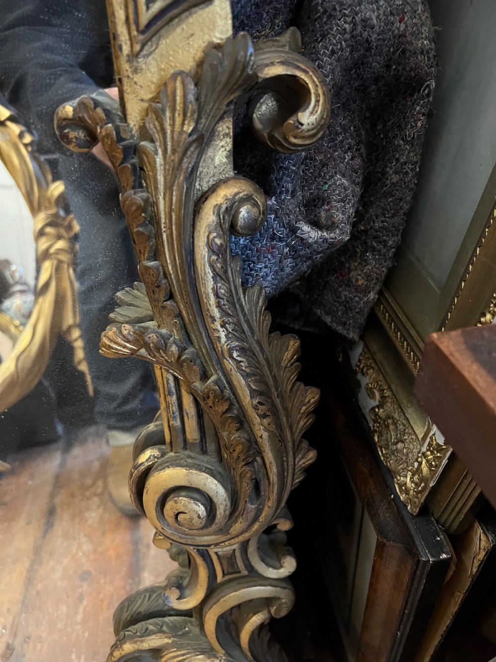 A 19th-century carved giltwood pier mirror featuring a Rococo cresting, scrolling acanthus leaf details, and an arched upper frame. View V