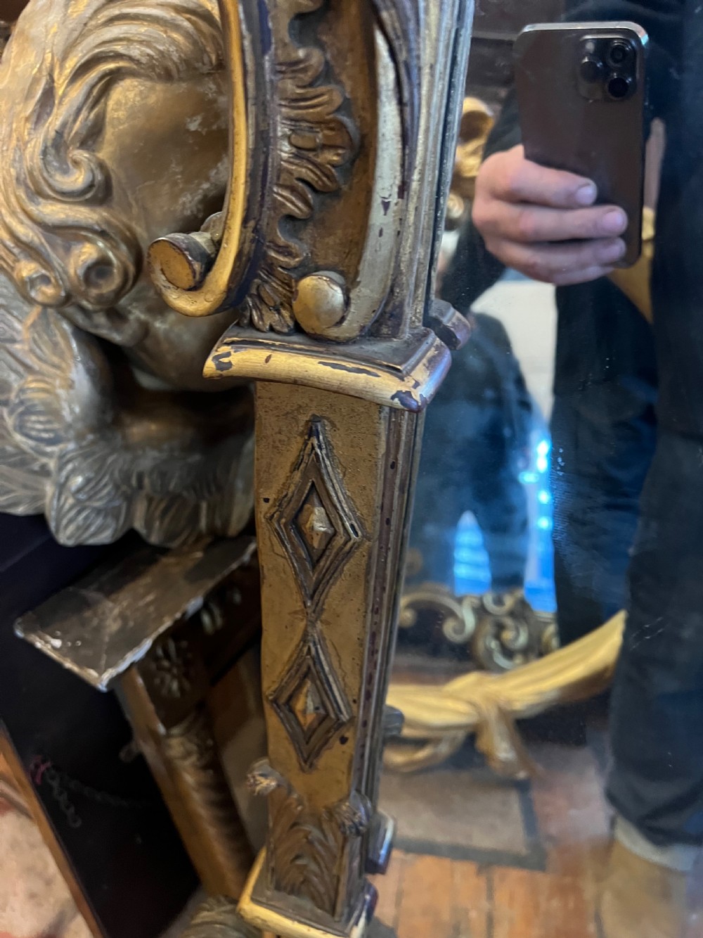 A 19th-century carved giltwood pier mirror featuring a Rococo cresting, scrolling acanthus leaf details, and an arched upper frame. View VI
