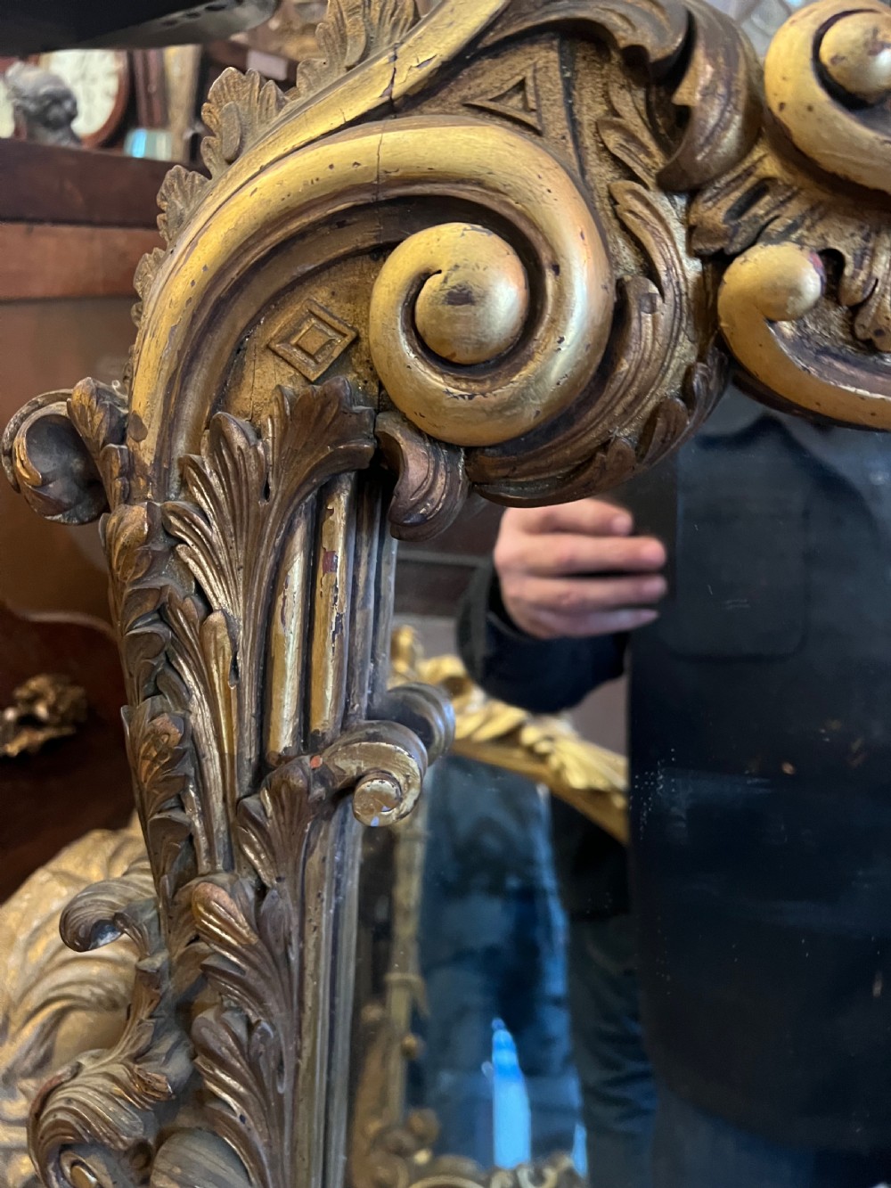A 19th-century carved giltwood pier mirror featuring a Rococo cresting, scrolling acanthus leaf details, and an arched upper frame. View VII