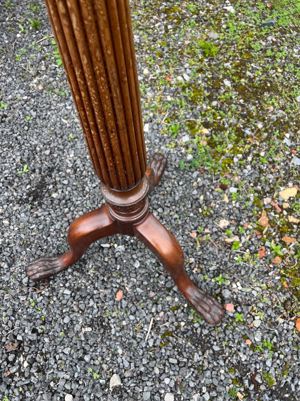 A tall nineteenth-century mahogany pedestal stand featuring a fluted column, acanthus leaf carving, and a tripod base with carved feet. View IV