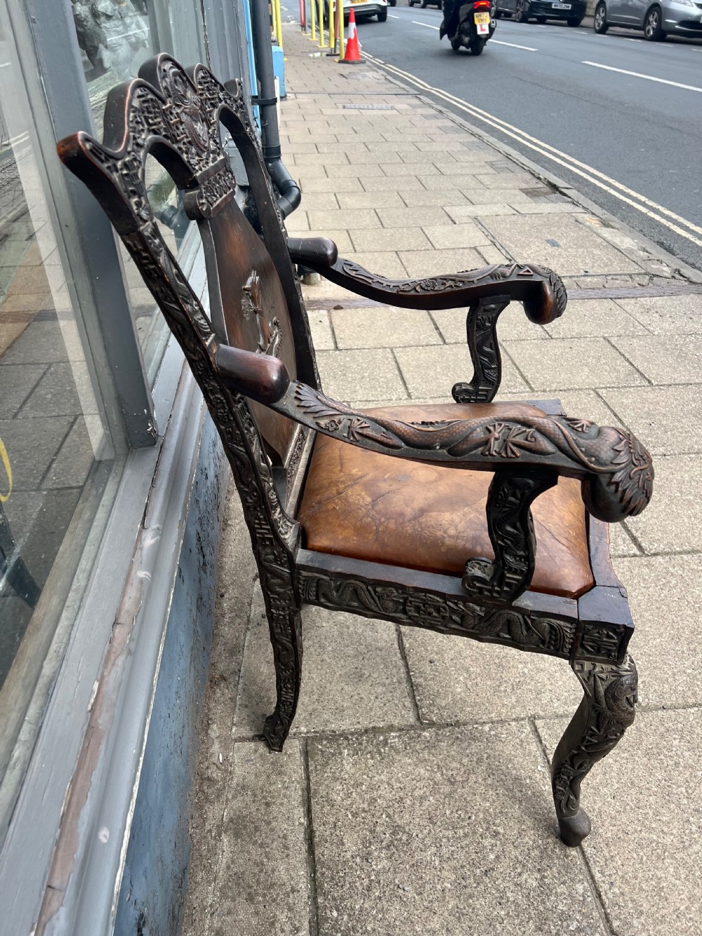 A pair of early C19th Chinese armchairs with crest to centre  View III