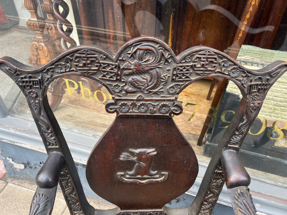 A pair of early C19th Chinese armchairs with crest to centre  View V