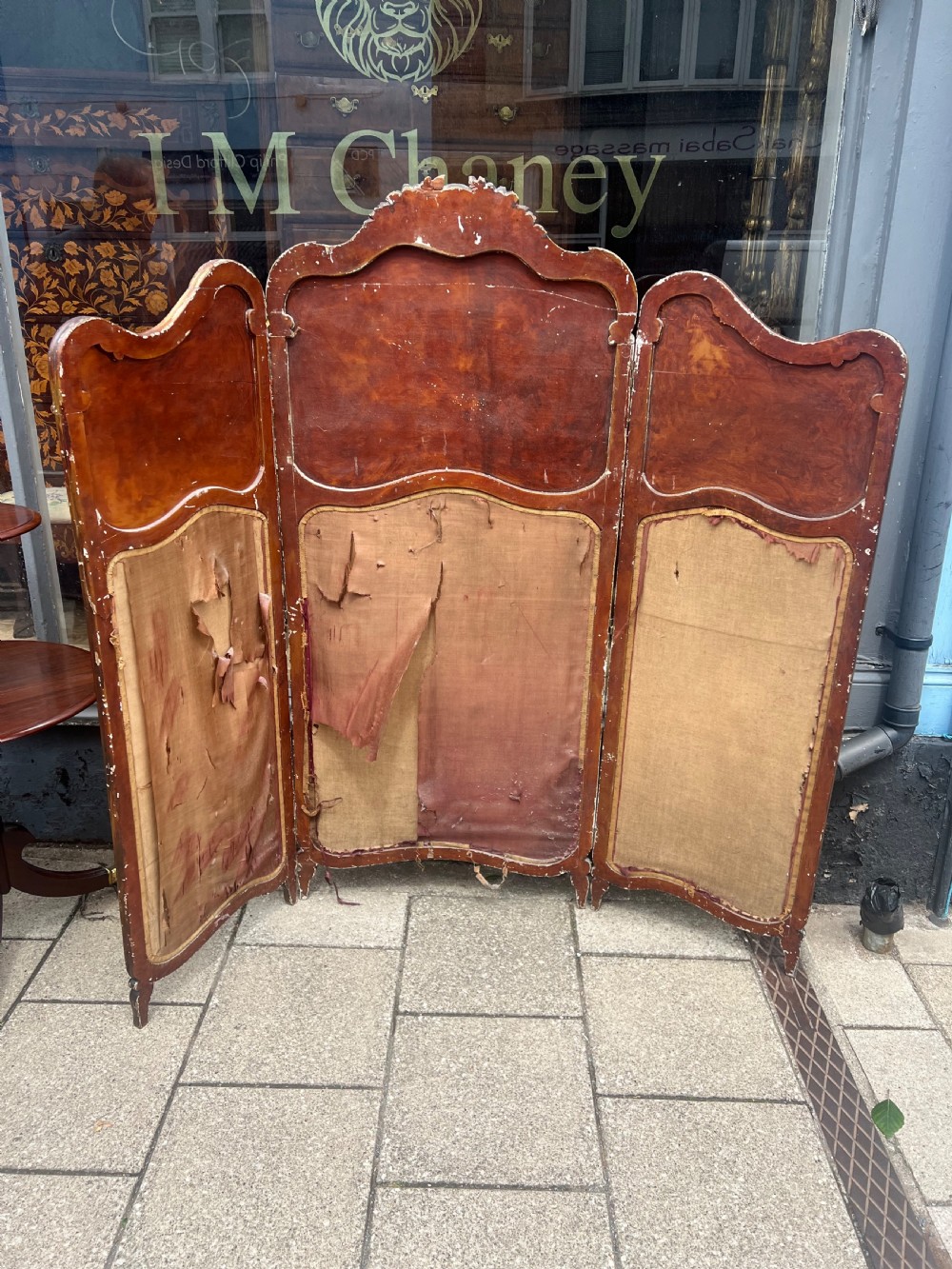 A three-panel French modesty screen featuring carved timber frames with oil-painted pastoral scenes on the upper panels and gold velvet upholstery on the lower panels. View III