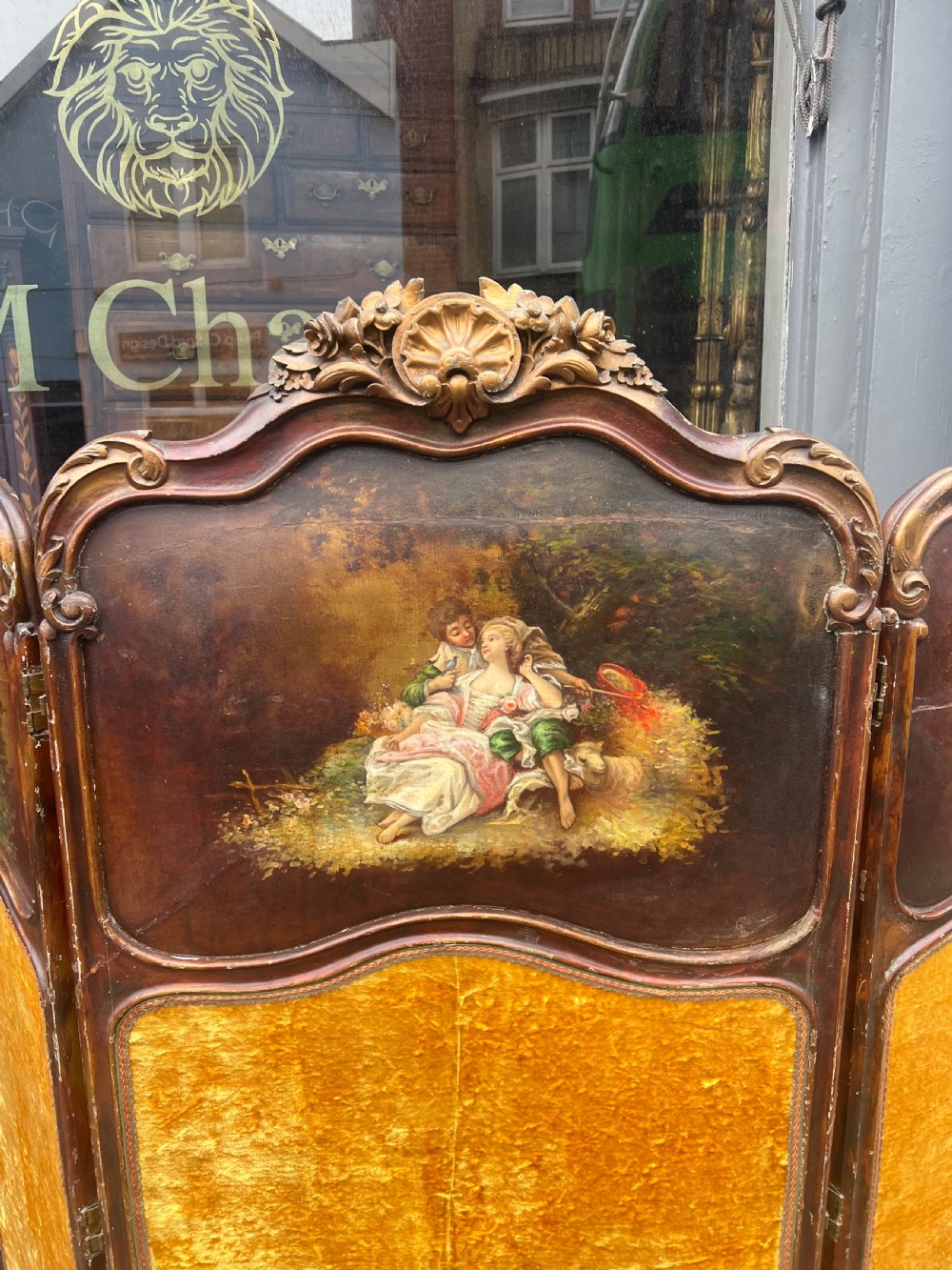 A three-panel French modesty screen featuring carved timber frames with oil-painted pastoral scenes on the upper panels and gold velvet upholstery on the lower panels. View VIII