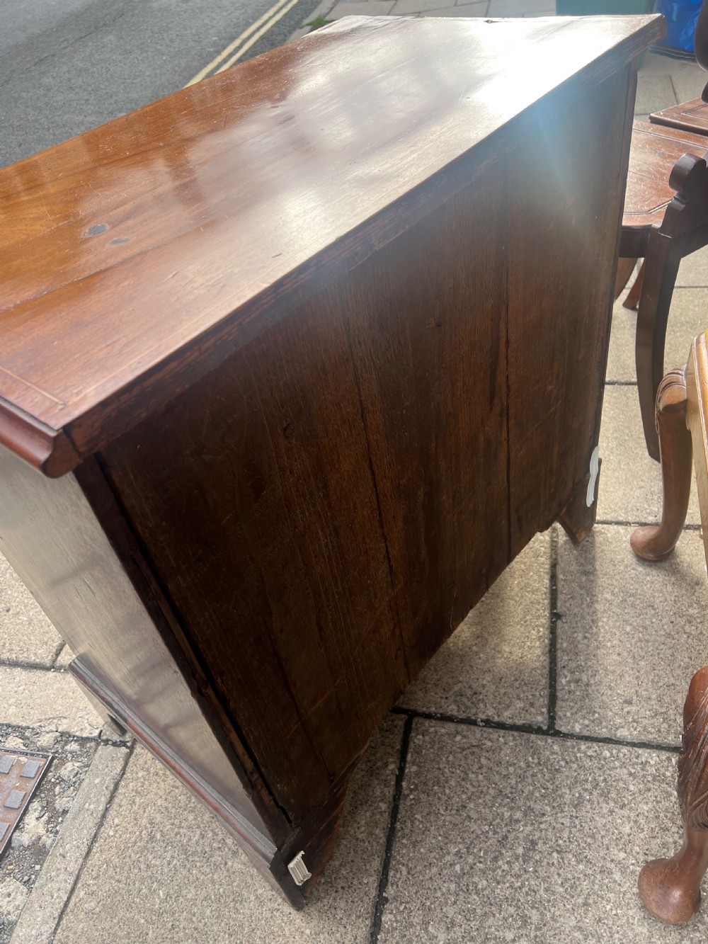 A Georgian mahogany chest of drawers with four full-width drawers, oval brass handles, brass escutcheons, and bracket feet. View VIII