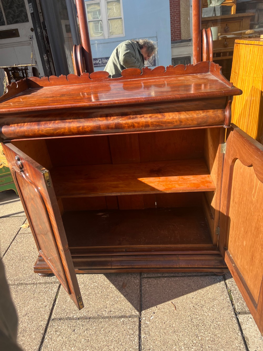 A William IV flame mahogany side cabinet with twin arch-panelled doors, a cushion frieze drawer, and a shaped gallery top rail. View VII
