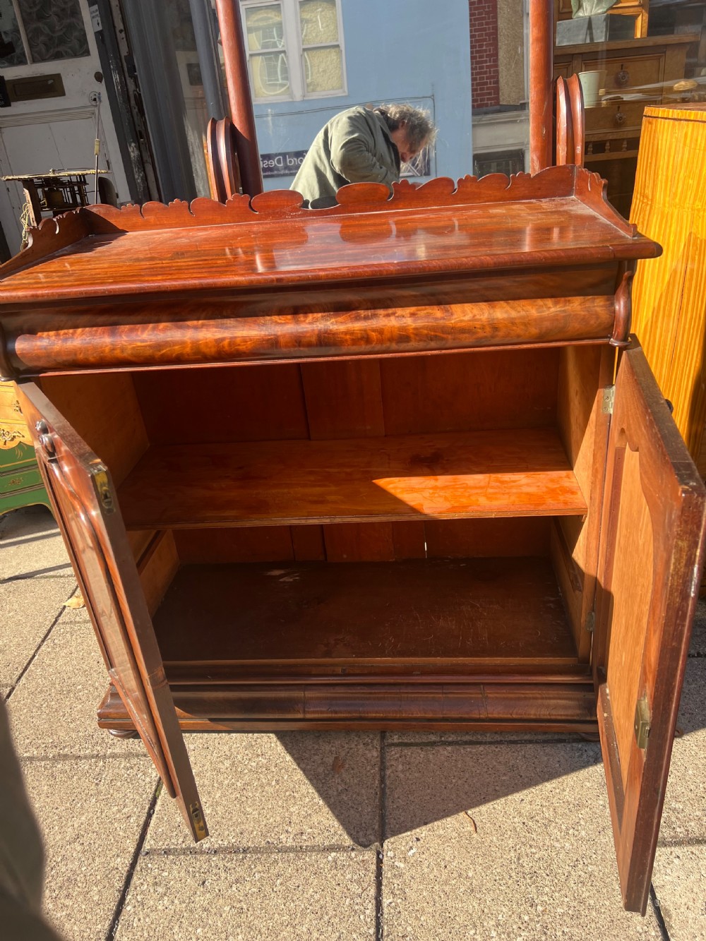 A William IV flame mahogany side cabinet with twin arch-panelled doors, a cushion frieze drawer, and a shaped gallery top rail. View VIII