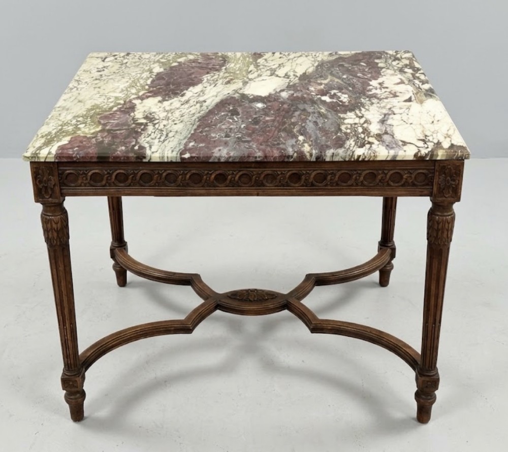 A rectangular side table featuring a Breccia Medicea violetta marble slab top set upon a carved timber frame with fluted legs and an X-shaped stretcher.