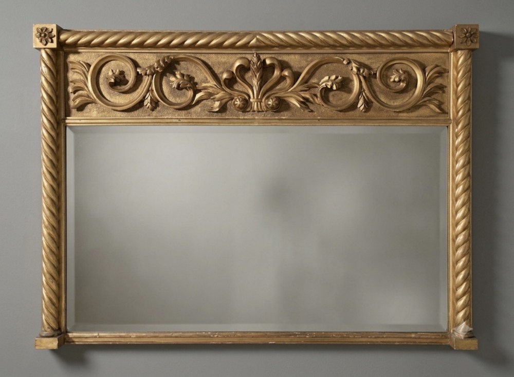 A horizontal 19th-century giltwood overmantel mirror featuring a rope-twist border, rosette corner blocks, and an acanthus leaf frieze.