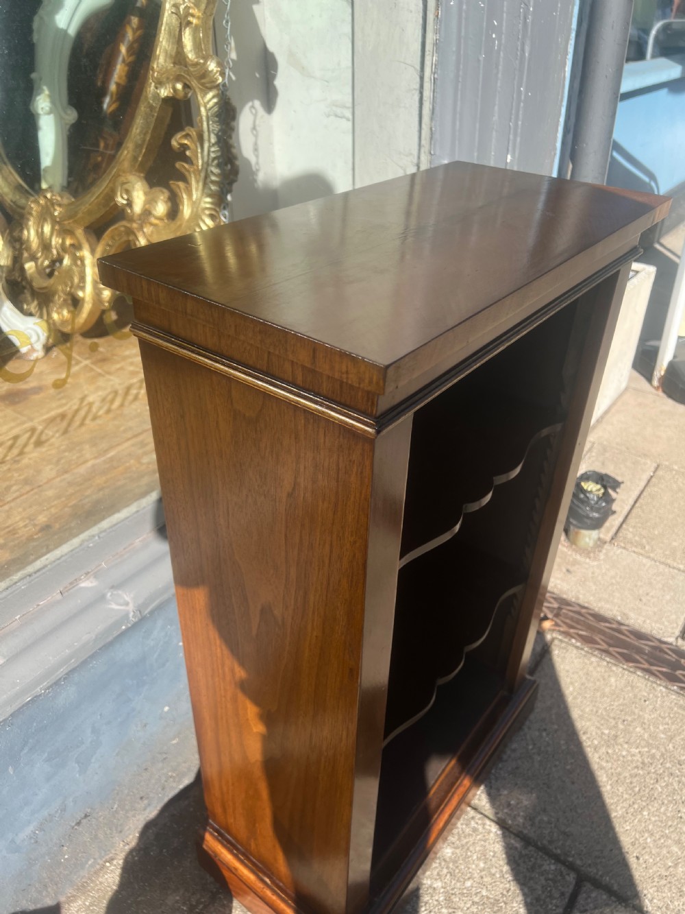 A small nineteenth-century mahogany open bookcase featuring three tiers with shaped shelf fronts and a plinth base. View III