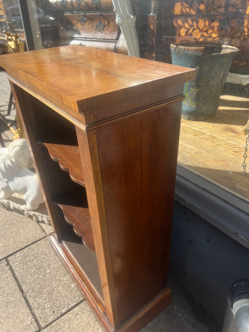A small nineteenth-century mahogany open bookcase featuring three tiers with shaped shelf fronts and a plinth base. View IV