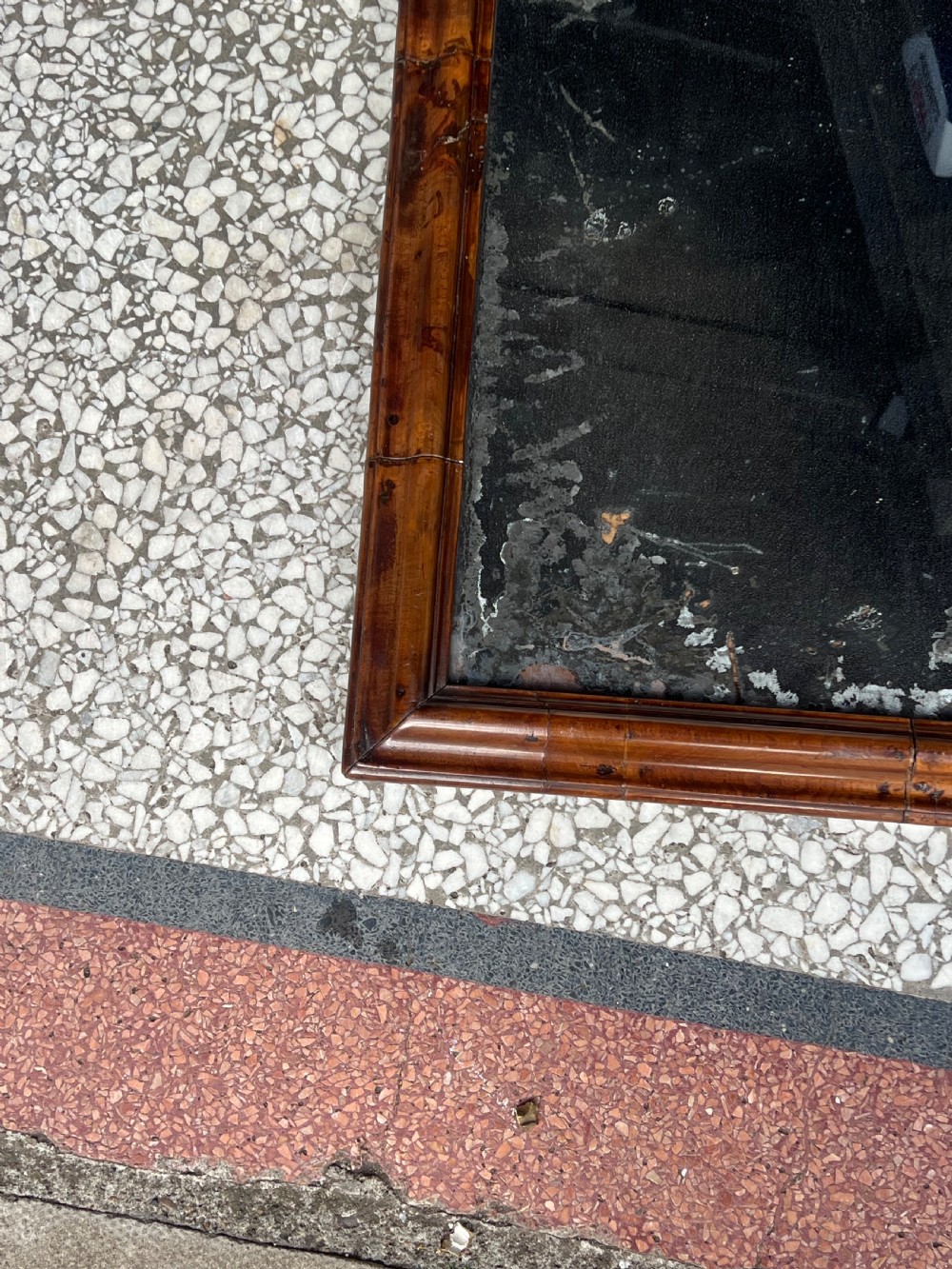 A rectangular 18th-century wall mirror featuring a moulded warm brown walnut wood frame enclosing heavily foxed and distressed glass. View II
