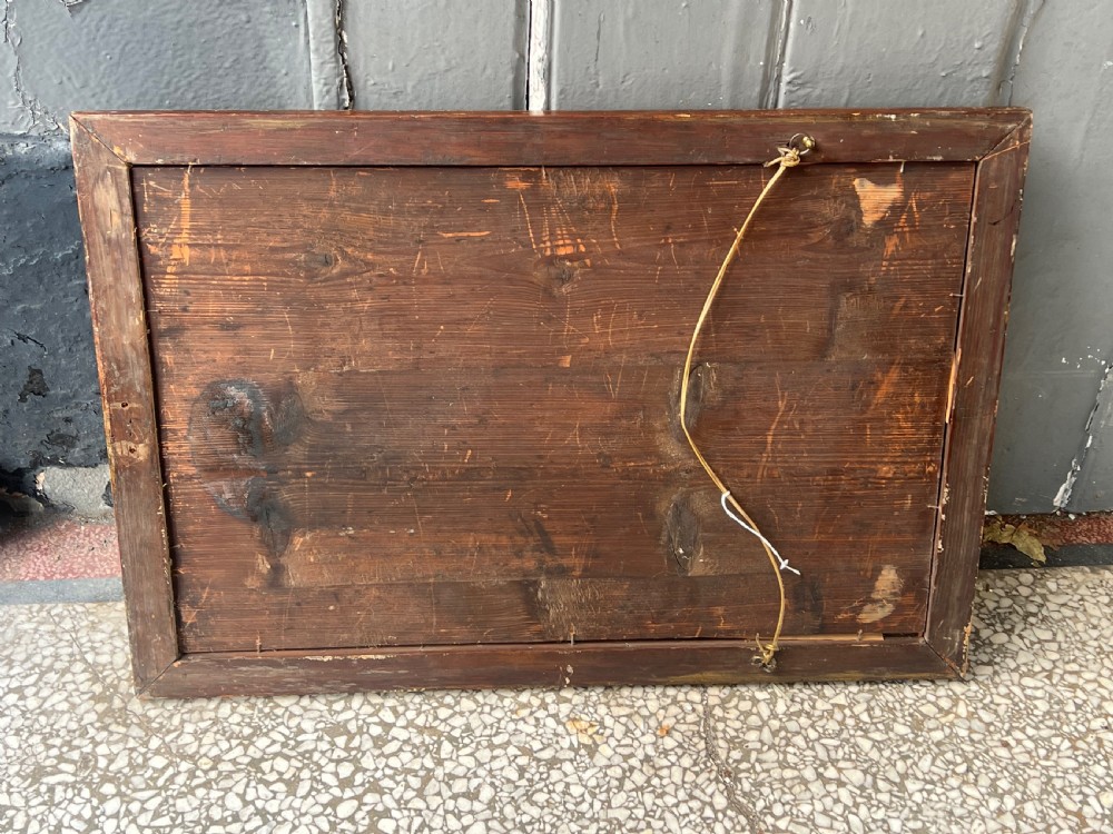 A rectangular 18th-century wall mirror featuring a moulded warm brown walnut wood frame enclosing heavily foxed and distressed glass. View VI