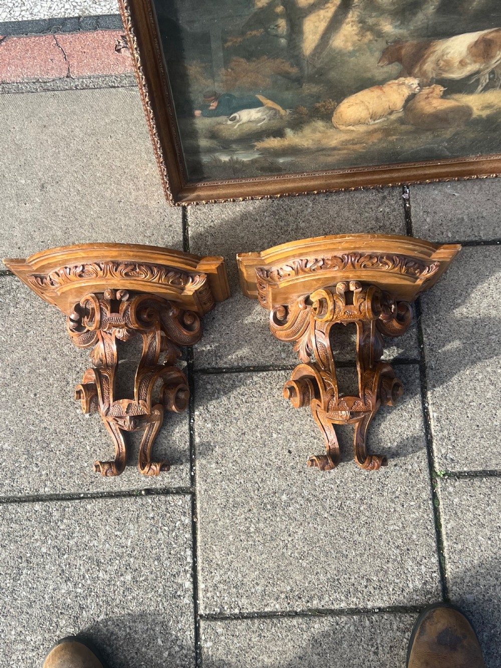 A matching pair of Georgian carved walnut wall brackets featuring intricate scrollwork and acanthus leaf detailing. View III