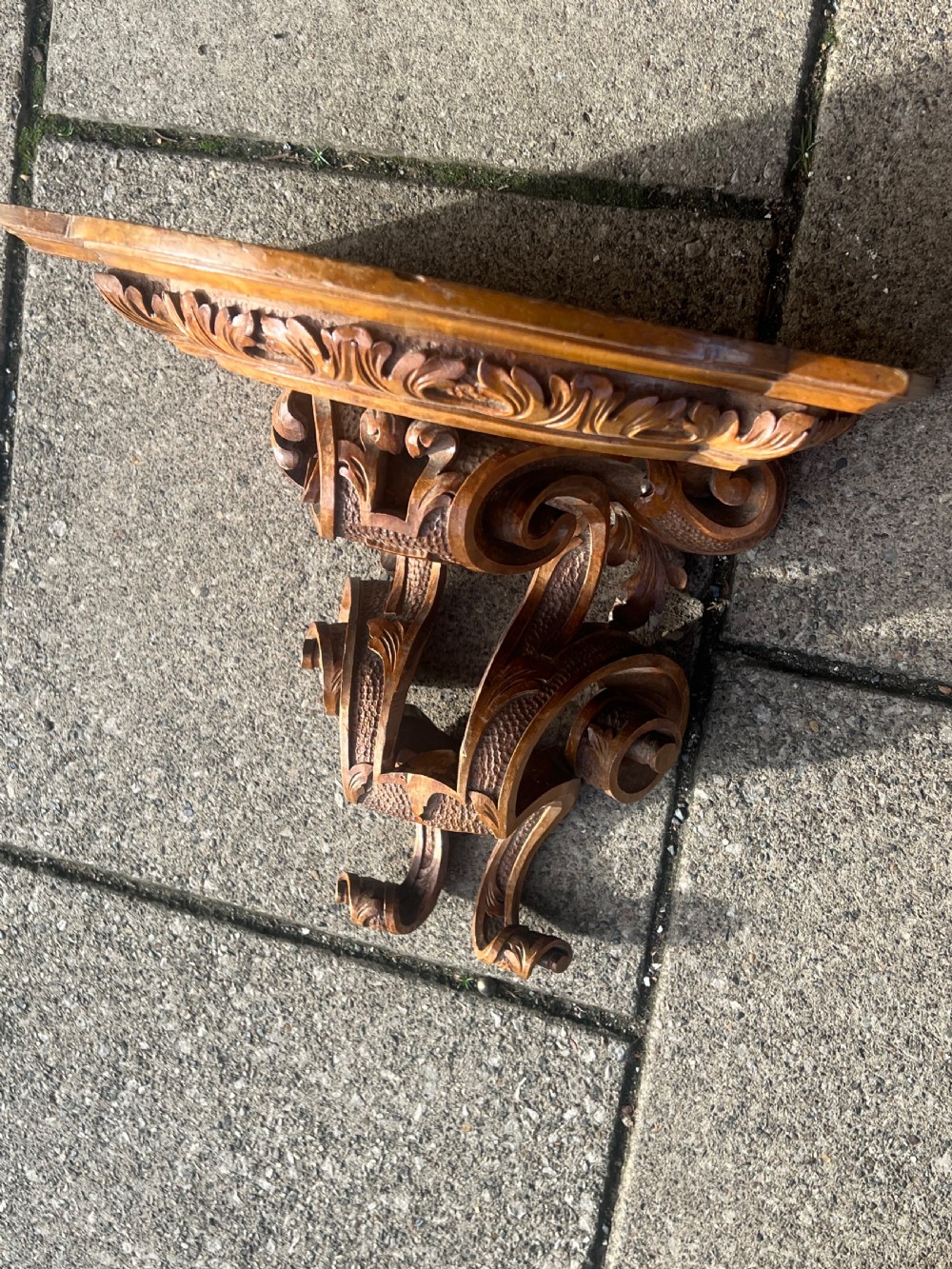 A matching pair of Georgian carved walnut wall brackets featuring intricate scrollwork and acanthus leaf detailing. View VIII