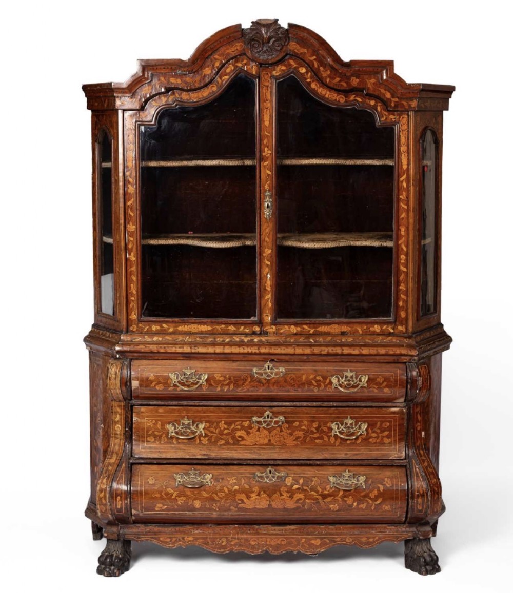 An eighteenth-century Dutch cabinet featuring detailed floral marquetry inlays, a shaped pediment above glazed double doors, and a three-drawer bombe base on carved feet.