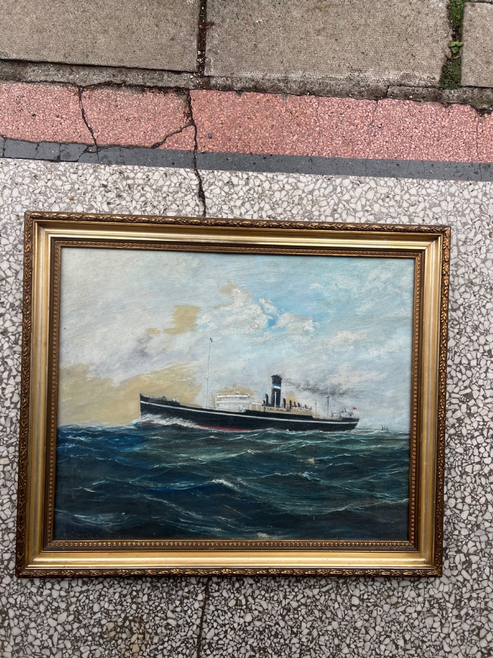 An oil painting on board depicting a black steamship navigating a blue sea with white waves, presented in a moulded gilt frame. View IV