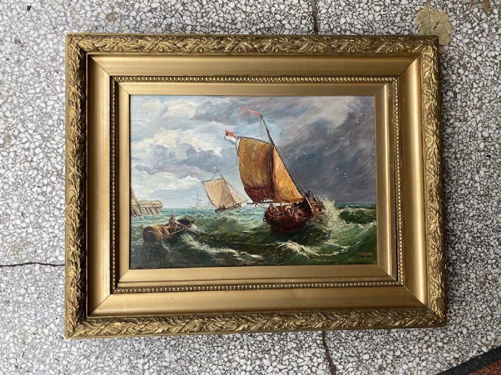 A pair of antique seascape oil paintings depicting sailing ships on choppy ocean waves, housed in matching gilt gesso frames. View III