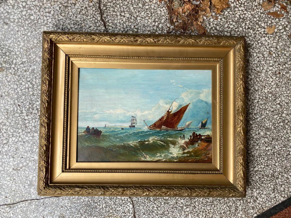 A pair of antique seascape oil paintings depicting sailing ships on choppy ocean waves, housed in matching gilt gesso frames. View IV