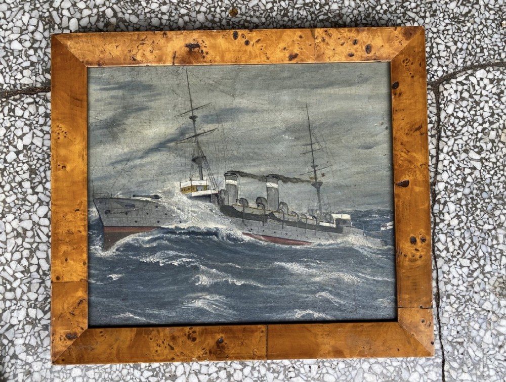 A framed oil painting depicting a Royal Navy cruiser, HMS Blenheim, navigating choppy grey seas within a broad burr maple wood frame. View II
