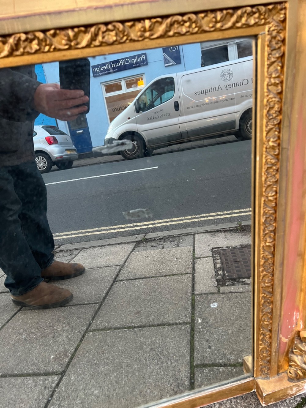 An ornate antique giltwood overmantel mirror featuring a carved acanthus leaf cresting and a decorative beaded inner frame. View X