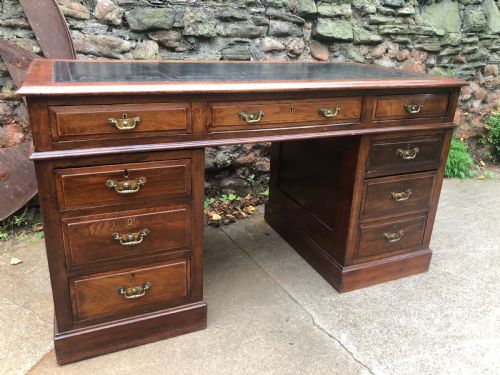 fig 1. C19th walnut nine drawer pedestal desk with inset leather top