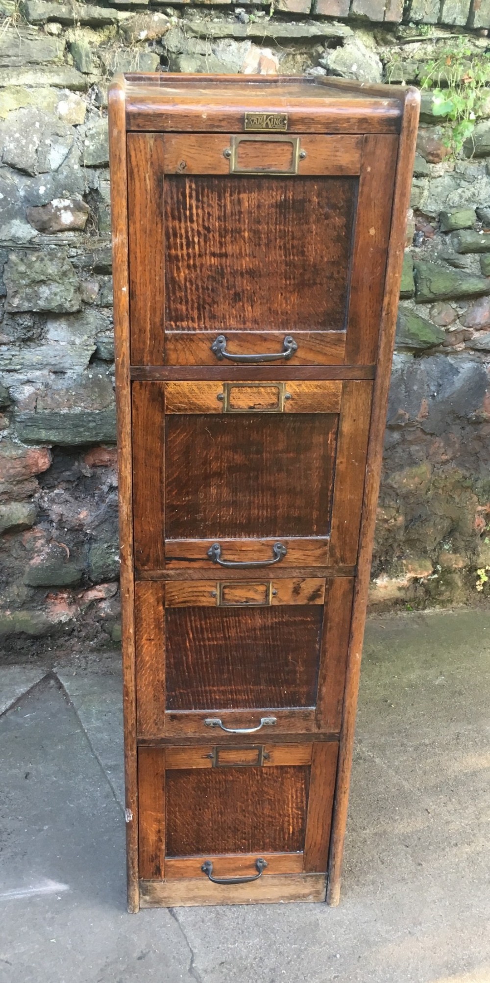 A Campbell King 1920s four drawer oak filing cabinet
