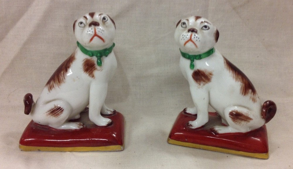 C19th Pair of miniature seated dogs on cushions