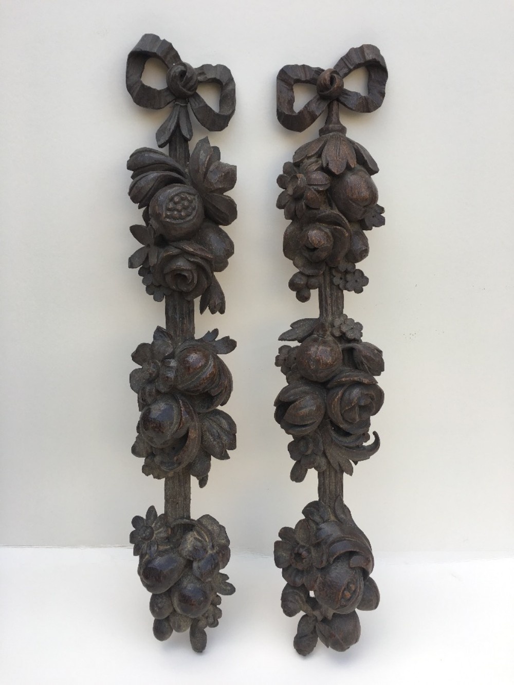 Pair of carved oak wall hangings 