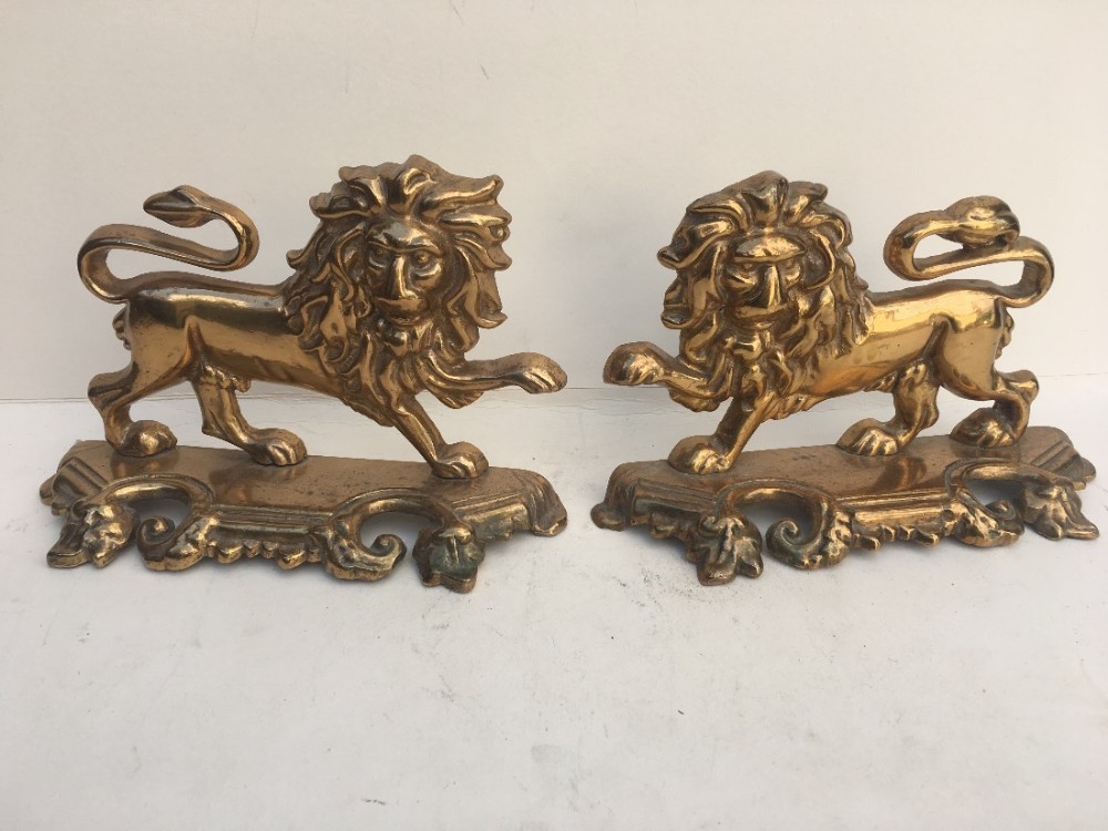 Pair of C19th brass lion ornaments 