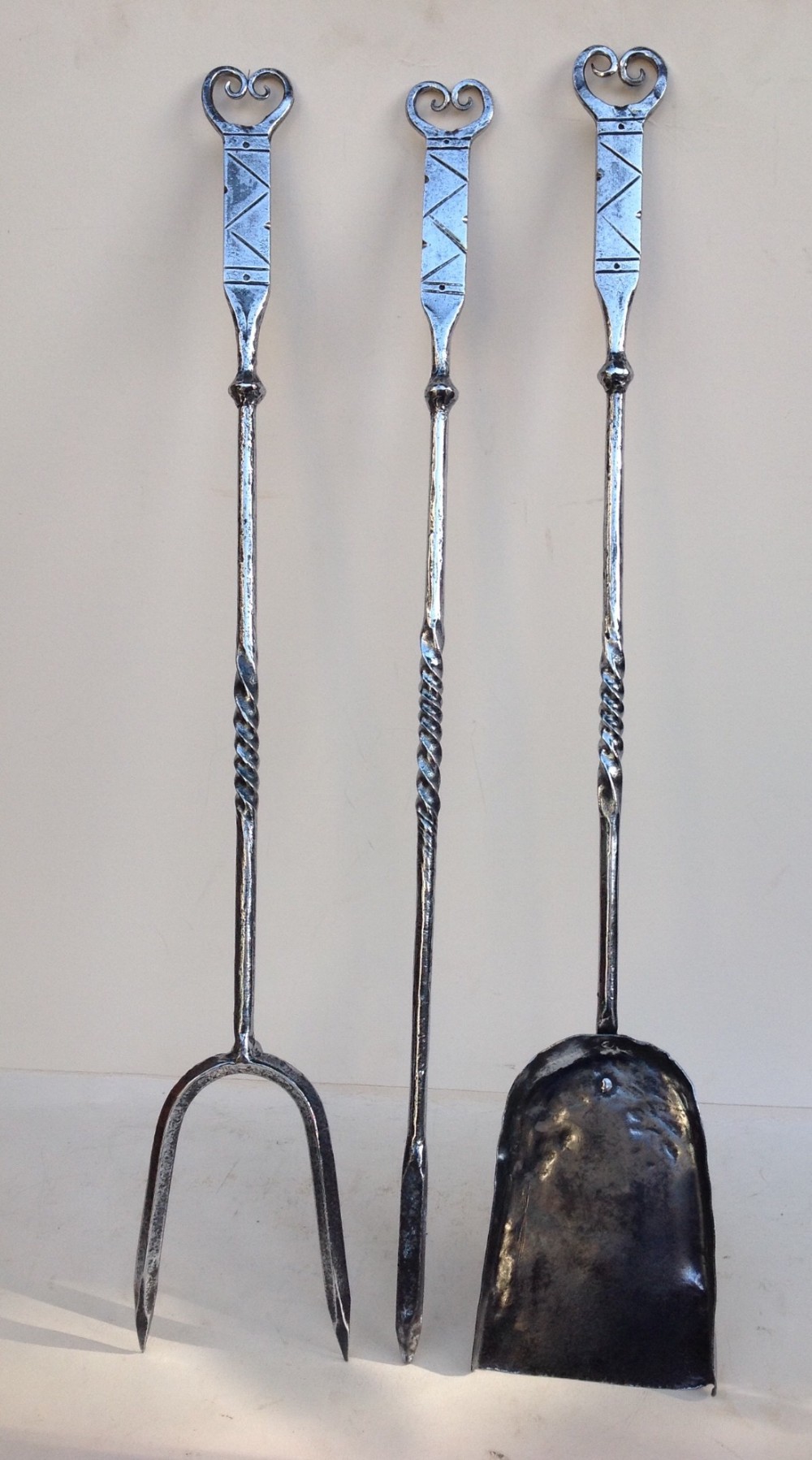 Set of three wrought iron fireside tools 