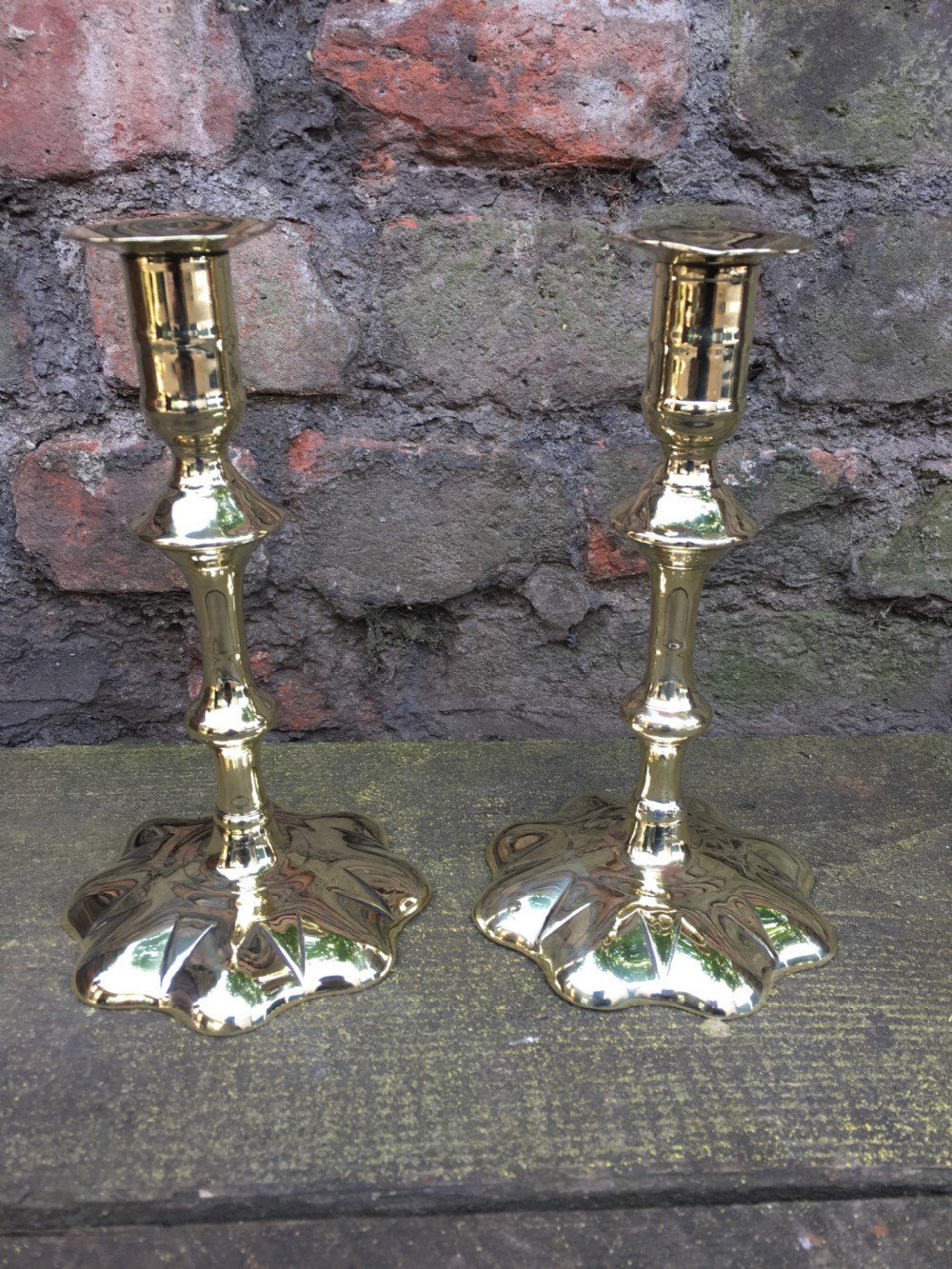 An C18th pair of petal based brass candlesticks  View III