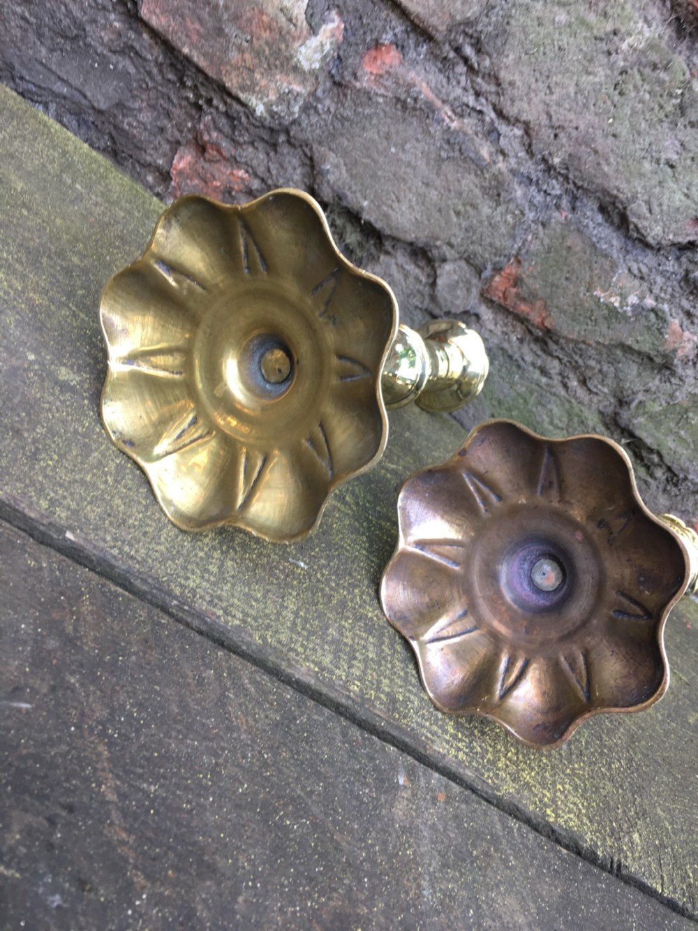 An C18th pair of petal based brass candlesticks  View V