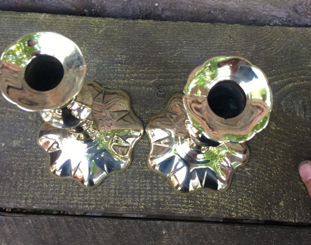 An C18th pair of petal based brass candlesticks  View VI