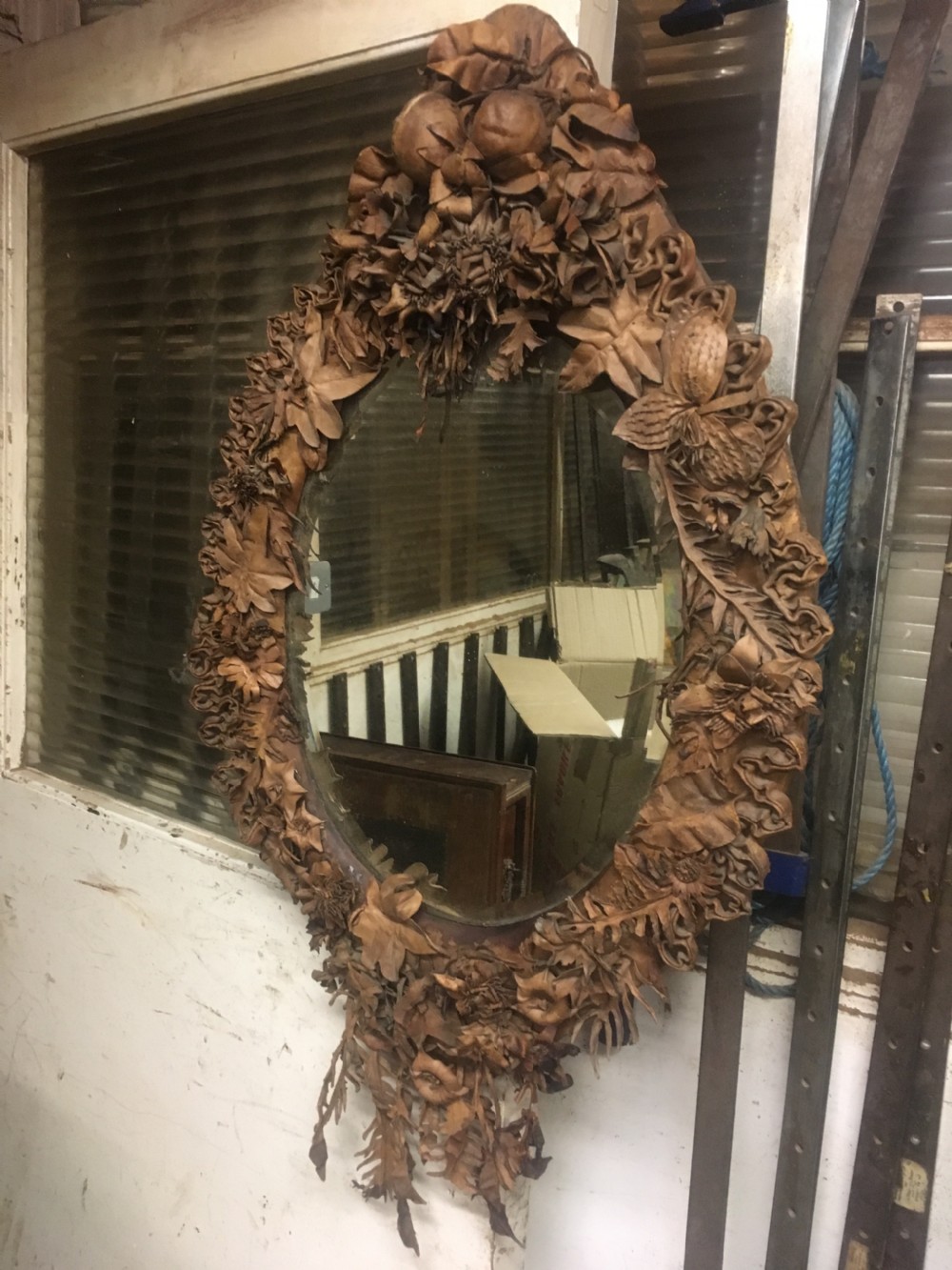 oval folk art mirror  decorated with shaped leather View III
