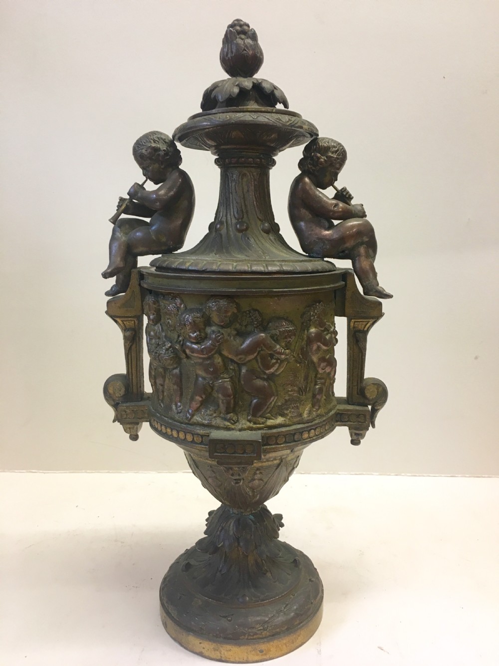 C19th gilt classical metal vase with cherub decoration